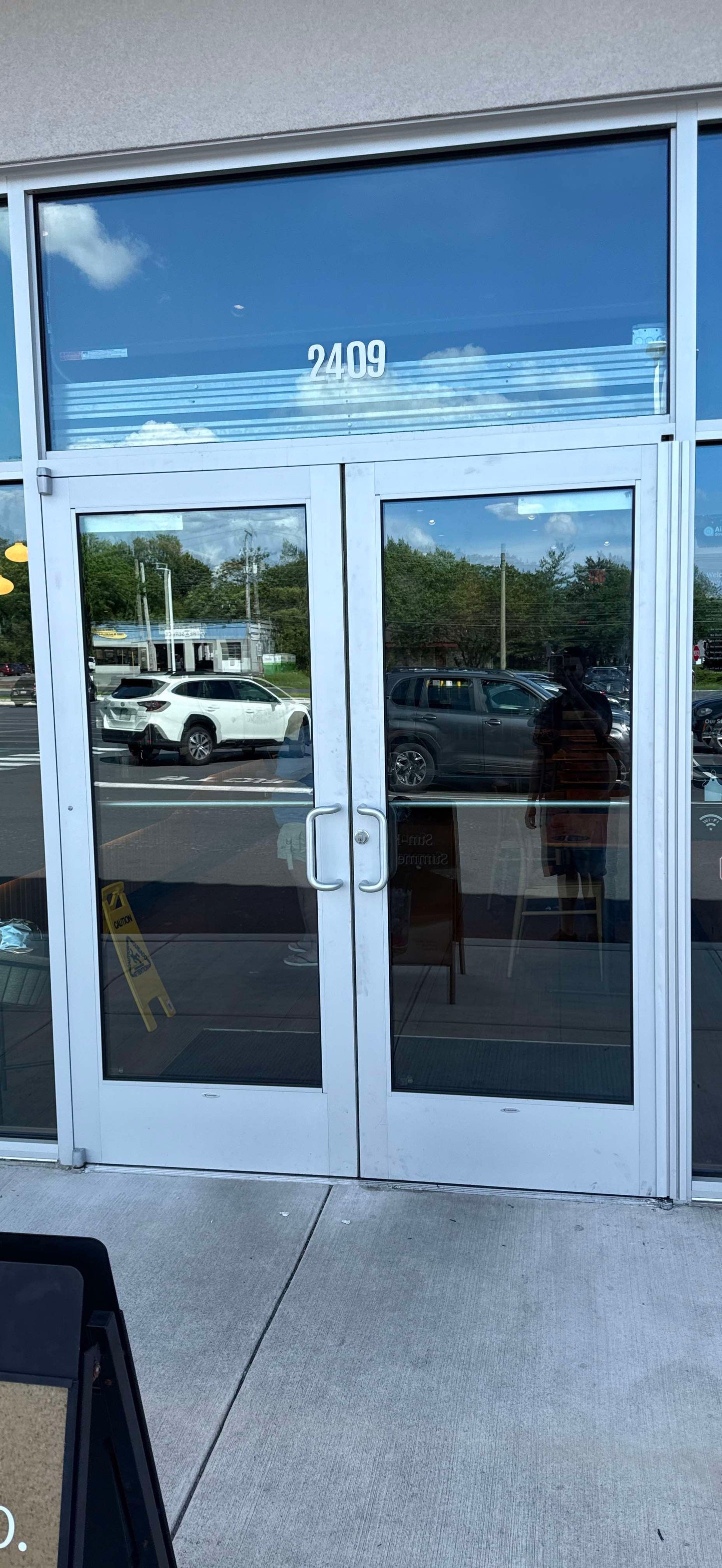 Technician performing emergency glass repair at commercial property