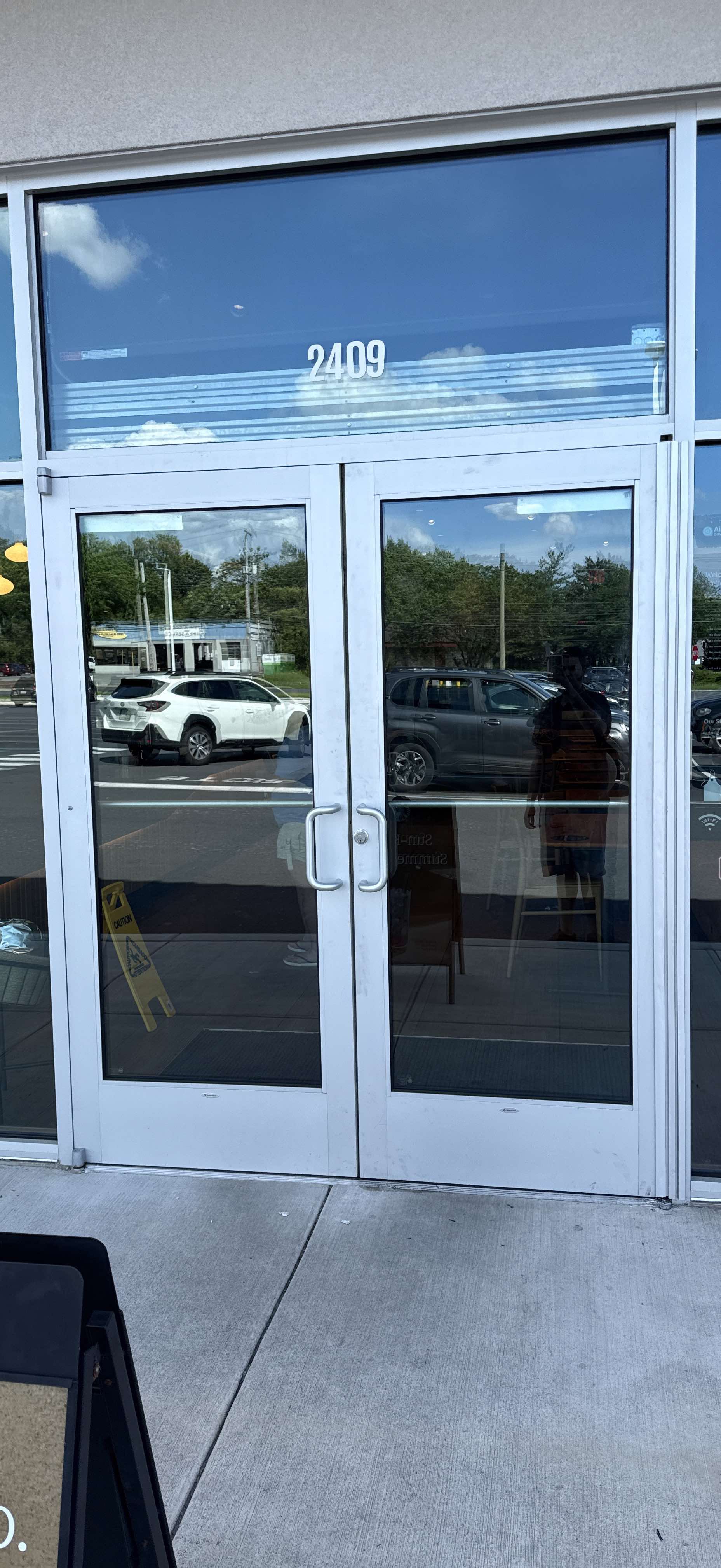 Technician performing emergency glass repair at commercial property