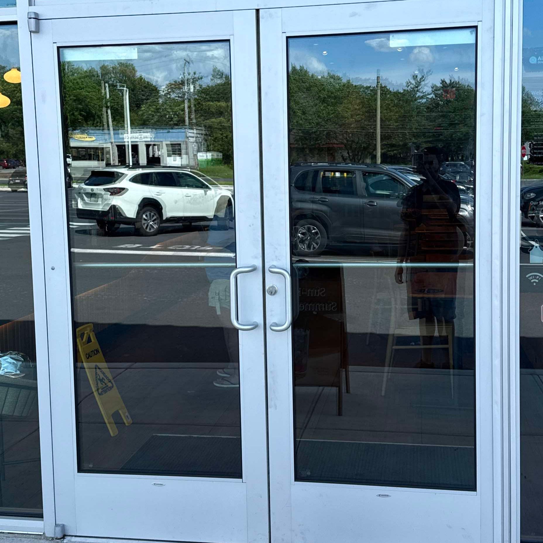 Emergency glass repair technician cleaning up after installation